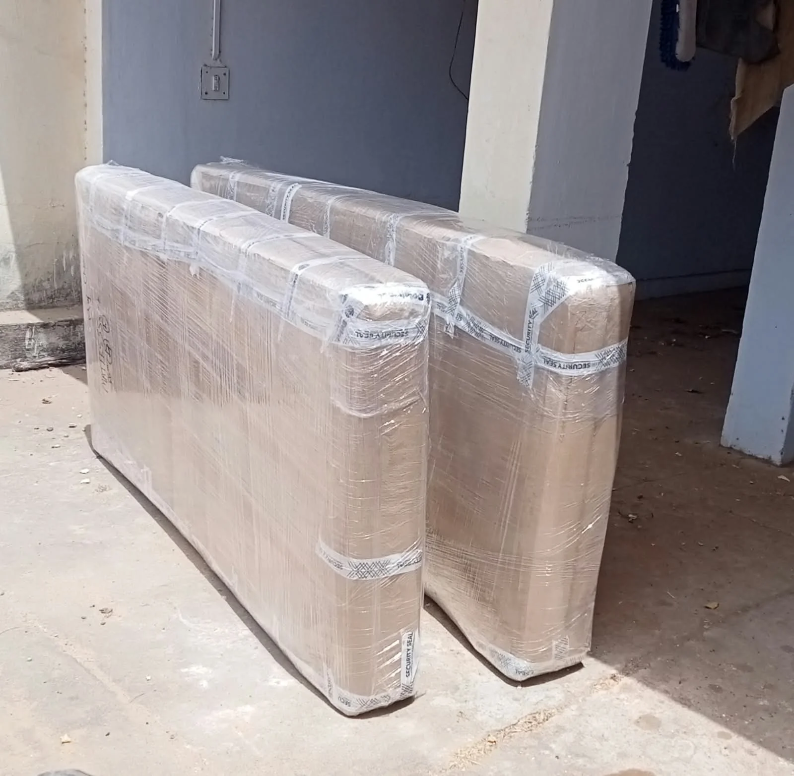 Carefully packed household goods and mattresses in waterproof wrap